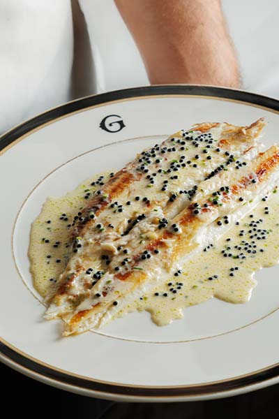 Giannino's seabass on a plate with signature Giannino G.