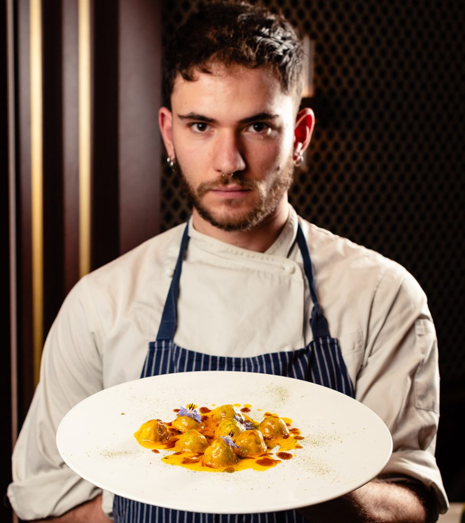 Giannino's head chef Nicola holding a delicious plate of food.